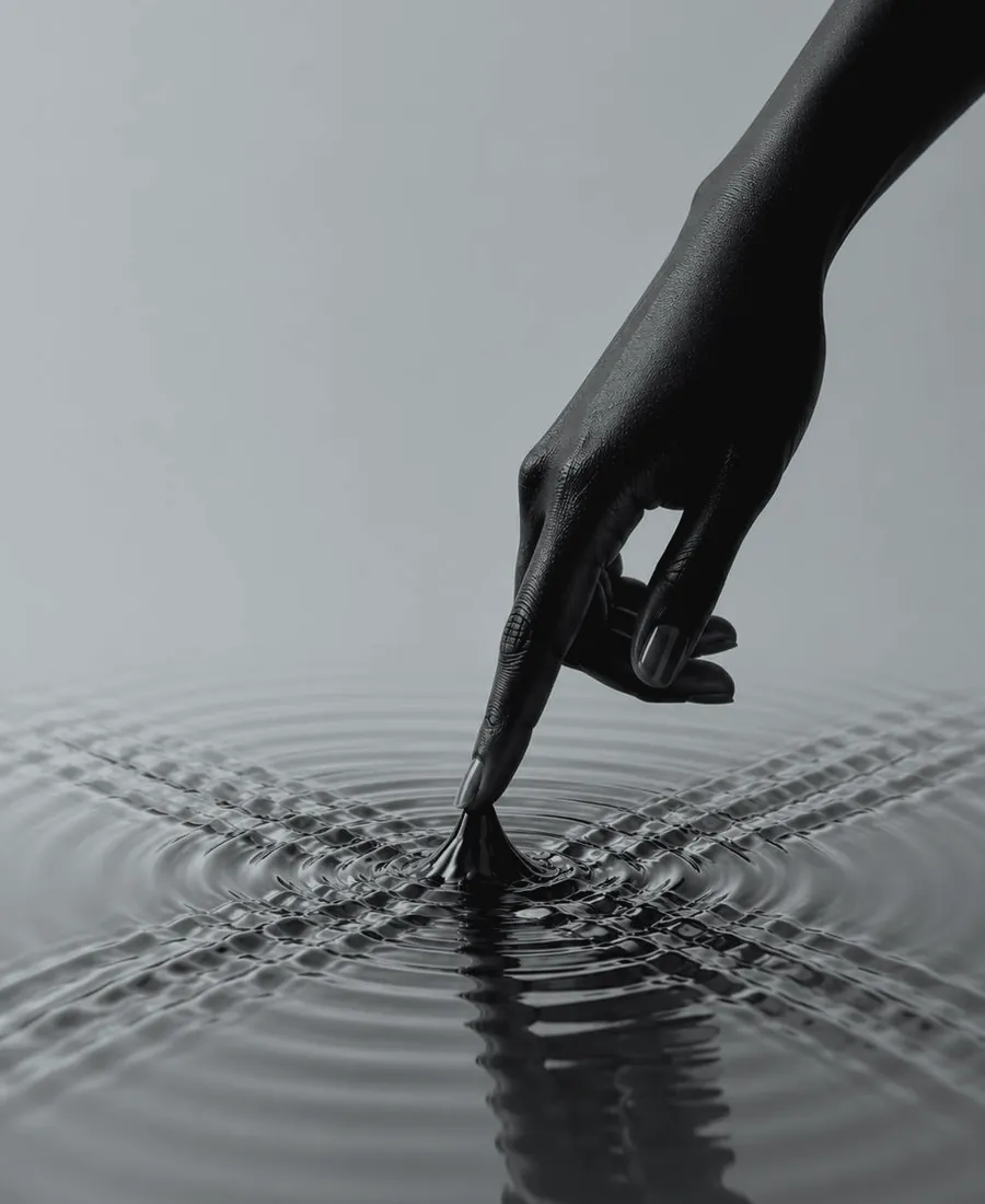 A finger touches a surface – close-up in duotone style.